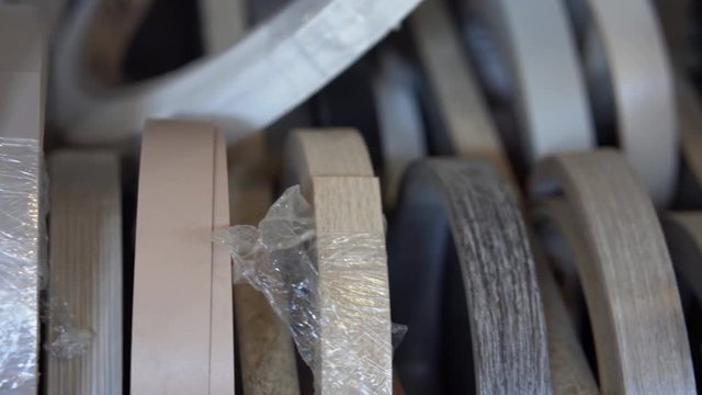 Furniture accessories. Multi Colored bobbins of PVC edge and melanin for the manufacture of furniture. Close-up