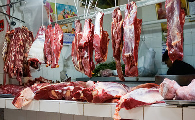 shop and stall of a butcher in Huaraz selling fesh meat in the market hall in Huaraz