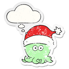 cartoon octopus wearing christmas hat and thought bubble as a distressed worn sticker