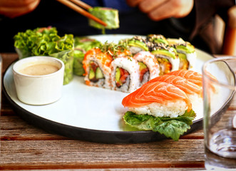 Sushi and nigiri  plate japanese style at the oudoors restaurant, soft focus