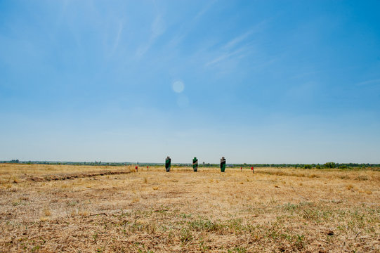 .Targets for shooting in form of silhouettes of people painted in camouflage colors in field in open space
