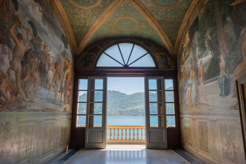 Doorway to balcony with distant view of Como Villa Carlotta Tremezzo, Como Lake, Italy. - 276320344
