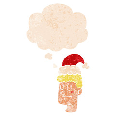 cartoon man wearing christmas hat and thought bubble in retro textured style