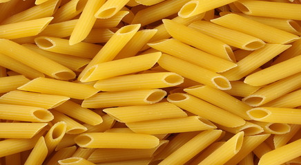 Penne rigate pasta background and texture, top view