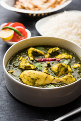 palak/spinach Chicken or Murg Saagwala served in a bowl with Naan and rice