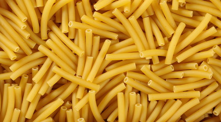 Macaroni, raw pasta in wooden food basket background and texture, top view