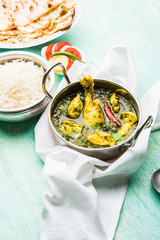 palak/spinach Chicken or Murg Saagwala served in a bowl with Naan and rice