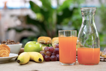 Breakfast including, bread, honey, orange juice, muesli and fruits