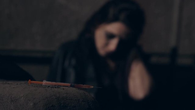 Drug Abuse. defocused Young woman after taking heroin dose