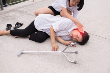 Senior asian woman faint lying down and unconscious outdoor,Daughter take care and support