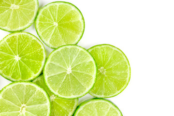 Fototapeta na wymiar Vibrant lime slices, shot from above on a white background with copy space