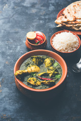 palak/spinach Chicken or Murg Saagwala served in a bowl with Naan and rice