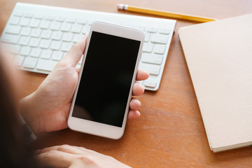Mock up. Blank digital smartphone in the hand of Asian women, Mobile phone black screen