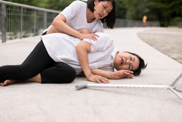 Elderly asian woman having chest pain suffering from heart attack,Daughter take care and support