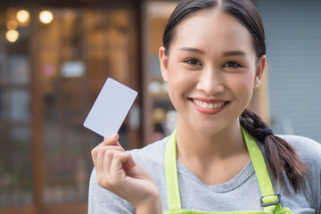 asian woman business owner showing blank credit card