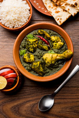 palak/spinach Chicken or Murg Saagwala served in a bowl with Naan and rice