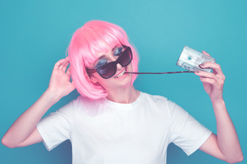 Young girl 90s and cassette on blue background.