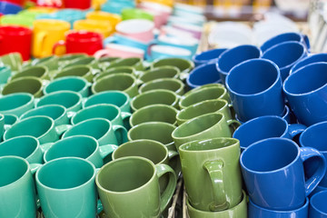 Many colorful empty ceramic cups.