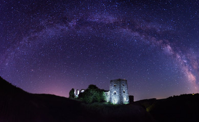 Arch of Milky way over the old castle