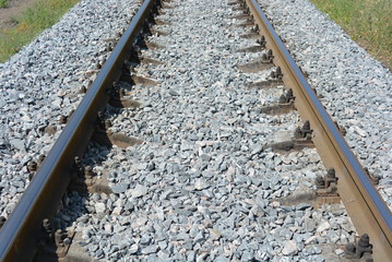 Repaired railroad tracks for freight trains with updated gray stone.