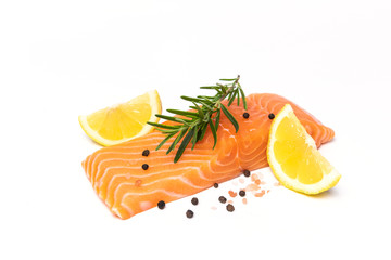 Fresh salmon steak with herbs and lemon isolated on white background