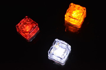 Beautiful plastic ice cubes with bright diode light. Red, yellow, white lighting for parties,...