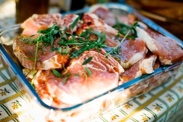 Pork meat with herbs in glass baker.
