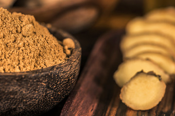 Ginger Powder in the Bowl and Sliced Ginger Root
