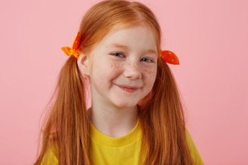 Close up of smiling petite freckles red-haired girl with two tails, smiling and looks cute, wears...
