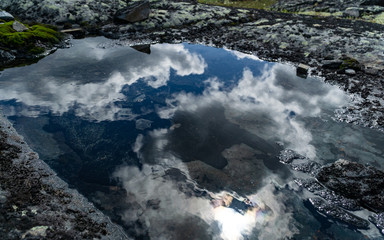 Clouds reflected in high mountain lake Khibiny