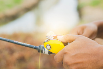 Hand holding a fishing rod