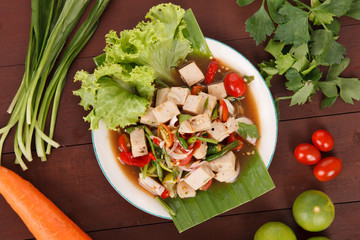 Hot and spicy sour Thai Salads. With white pork sausage and Chopped Mango. Mooyor.