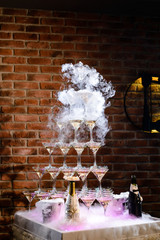 pyramid line of alcohol cocktails on open party wedding table
