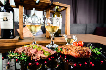 Obraz na płótnie Canvas Succulent grilled tomahawk beef steak on the bone with red wine, seasonings, fresh rosemary