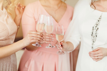 Close up of three women clinking with glasses of shampagne