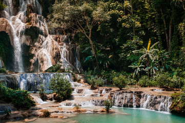 Blue water pond Kuang Si waterfall in Luang Prabang, Laos during summer season.