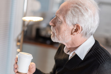 Thoughtful senior man during coffee break
