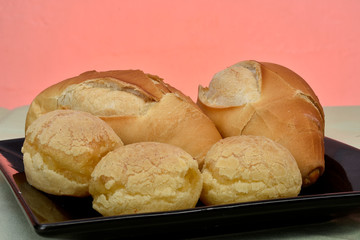 french bread and cheese bread on the plate with red background