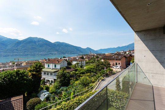 Glass balcony with a view of Lake Maggiore on a summer day