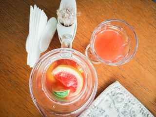 Peach and rosemary lemonade, cocktail on a gray stone concrete table background. Summer drink view from above.