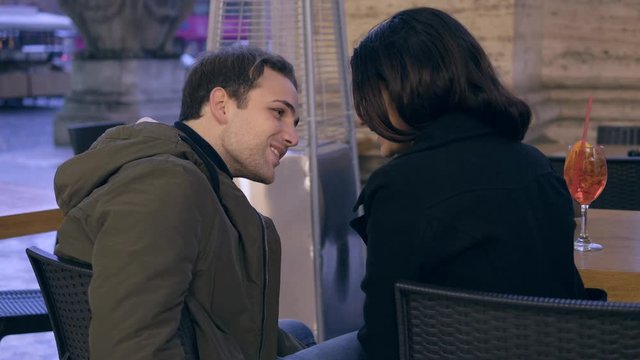 young man kissing her girlfriend and tapping in secret their friend.Infidelity 