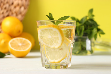 water with lemon on a colored background