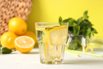 water with lemon on a colored background
