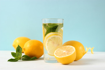 water with lemon on a colored background