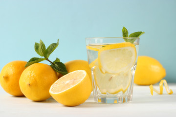water with lemon on a colored background