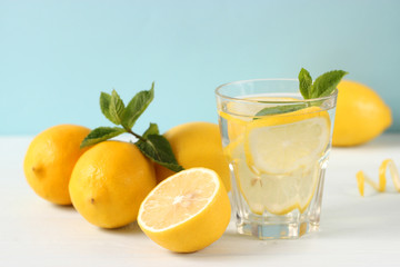 water with lemon on a colored background