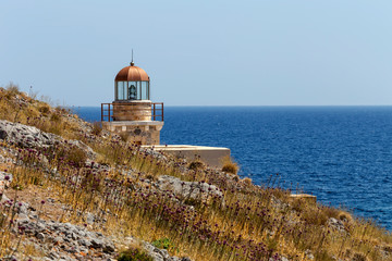 Lighthouse near the city Monemvasia against the background of the sea and sky (Greece, Peloponnese)