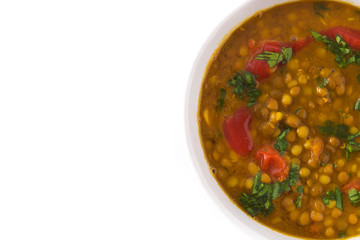 Indian lentil soup dal (dhal) in a bowl isolated on white background. Top view. Copyspace