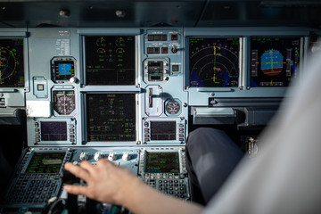 Pilot's hand accelerating on the throttle in  a commercial airliner airplane flight cockpit during takeoff