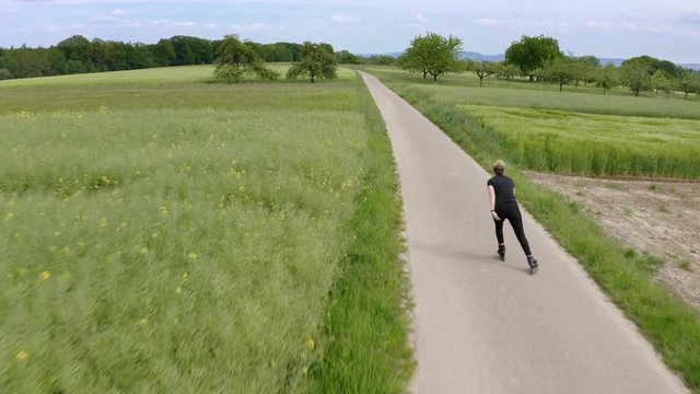 Aerial view of young woman inline skating